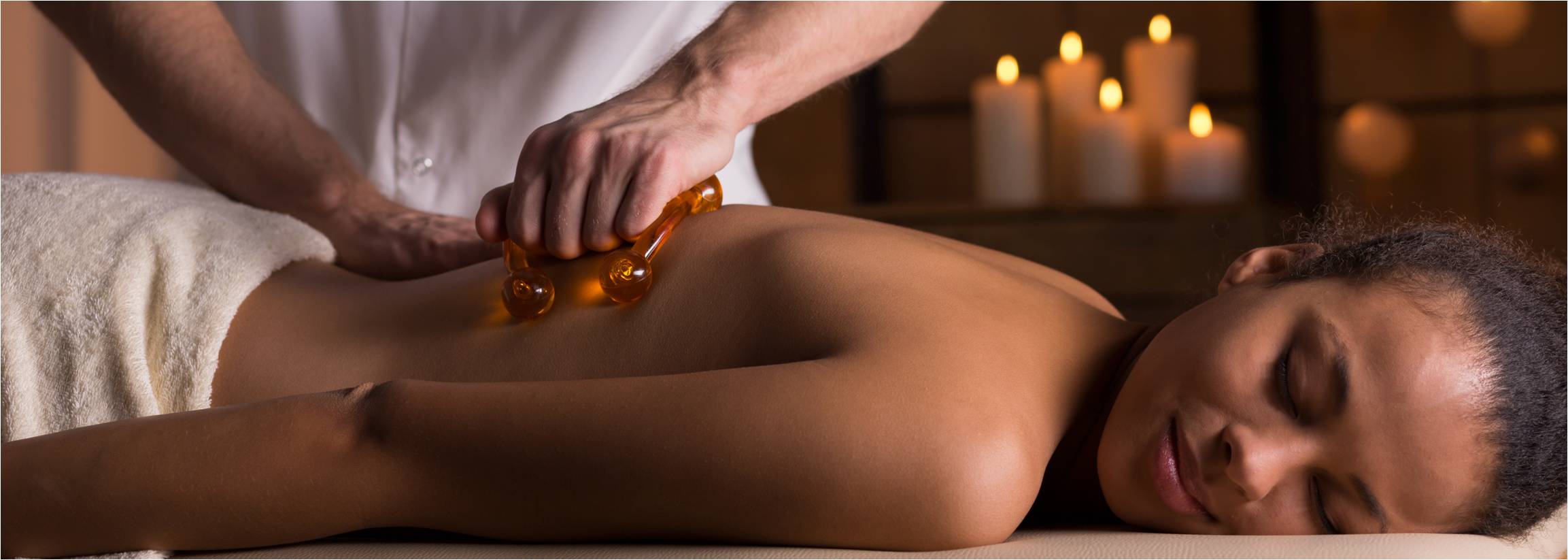 A woman getting a massage by a masseuse